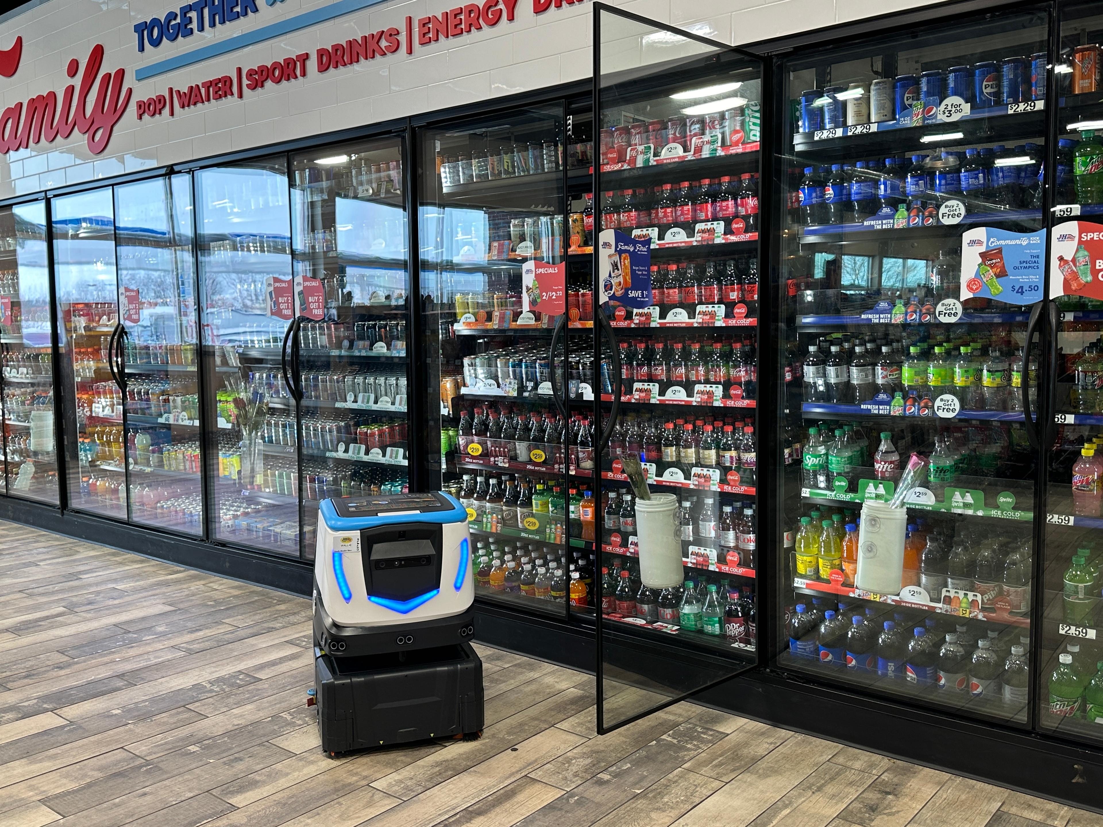 Cobi 18, autonomous floor scrubber navigating complex retail environment at J & H Family Stores