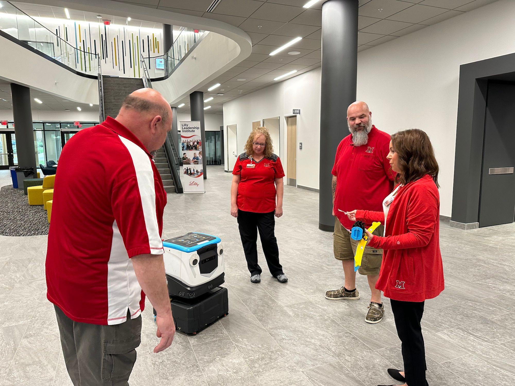 Building services staff being trained on how to use Cobi 18, robotic floor scrubber