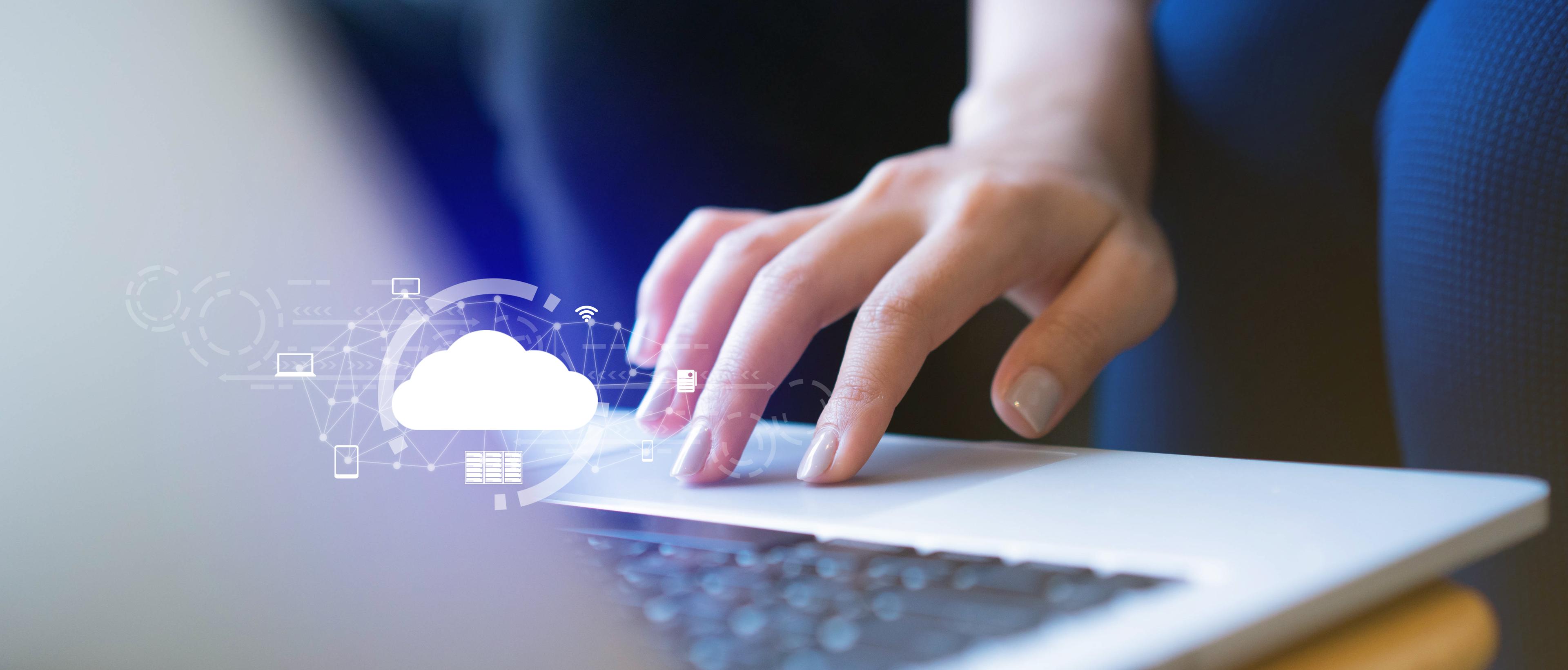 image of a person's hand working on a laptop while doing research 