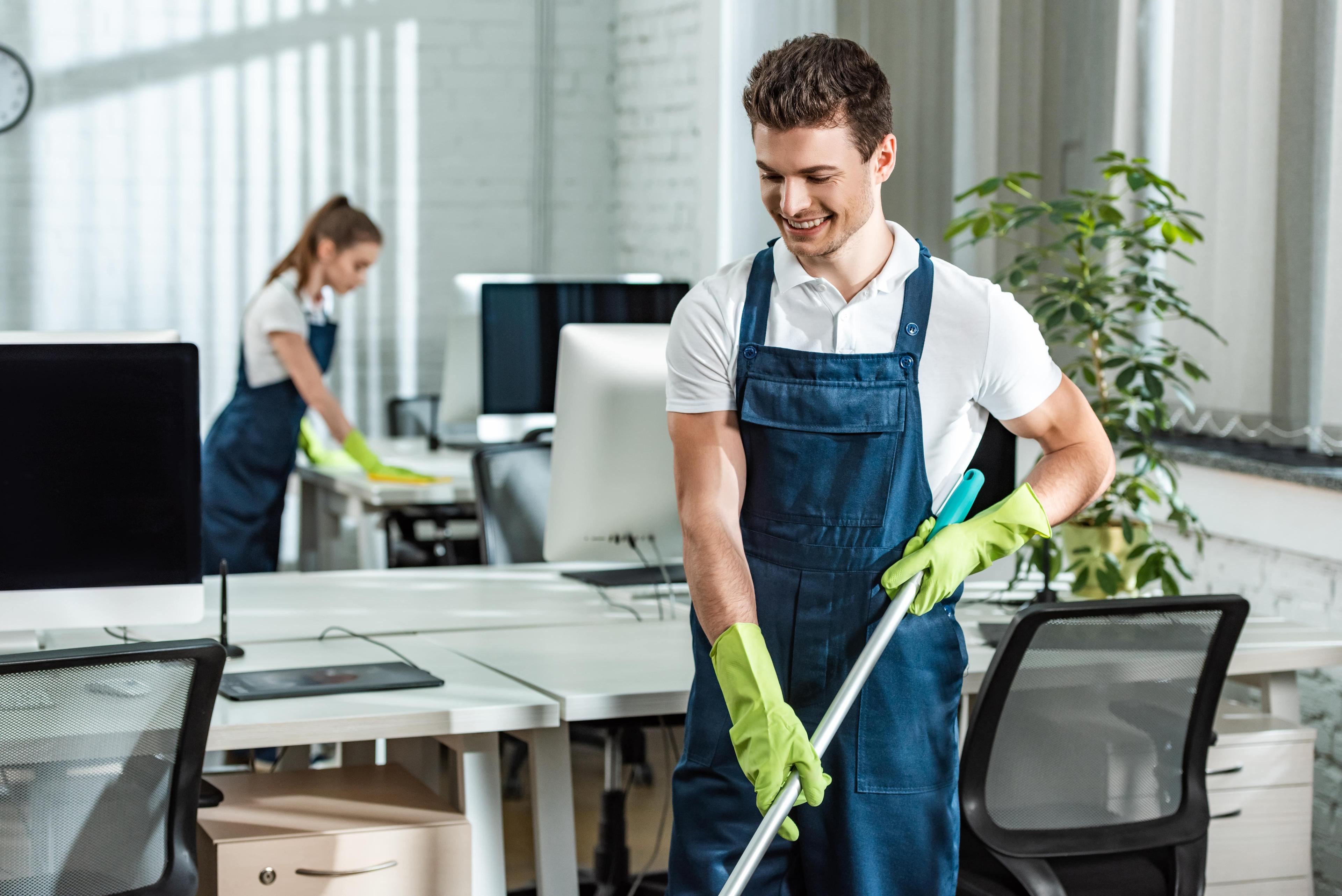 cleaning team members cleaning floors in office building 