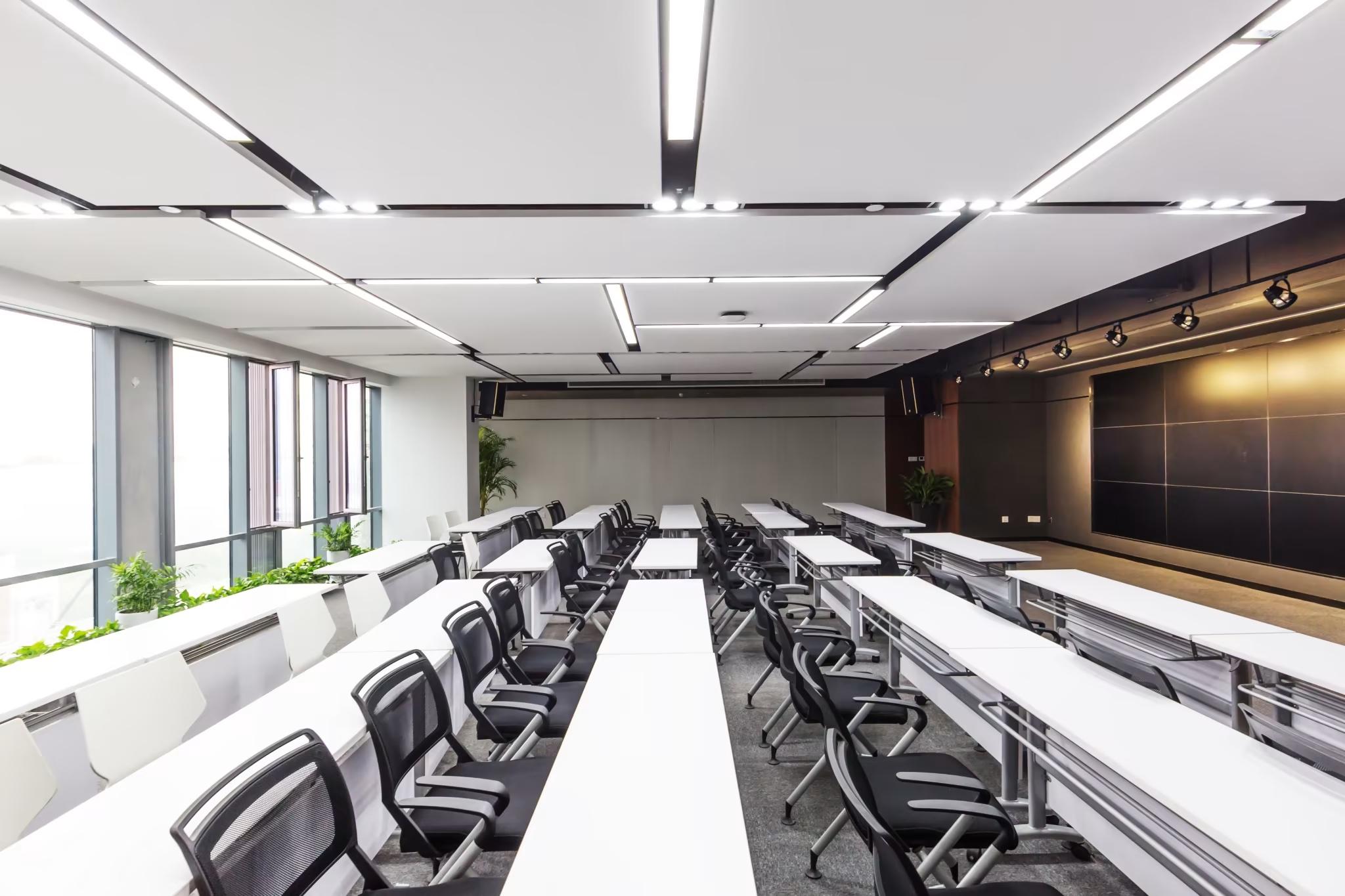 college campus classroom with long rows of desks and chairs at higher education facility