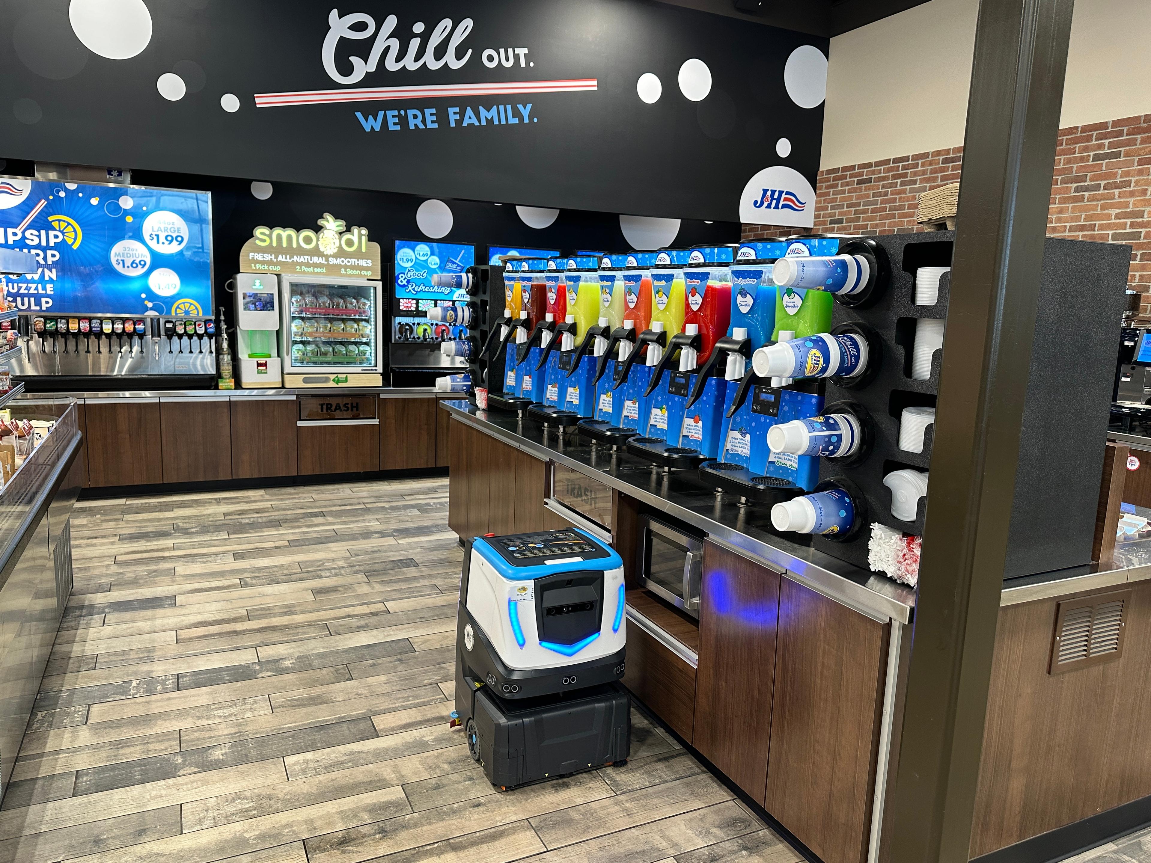 Cobi 18, robotic floor scrubber,  navigating around soda machines at convenience store