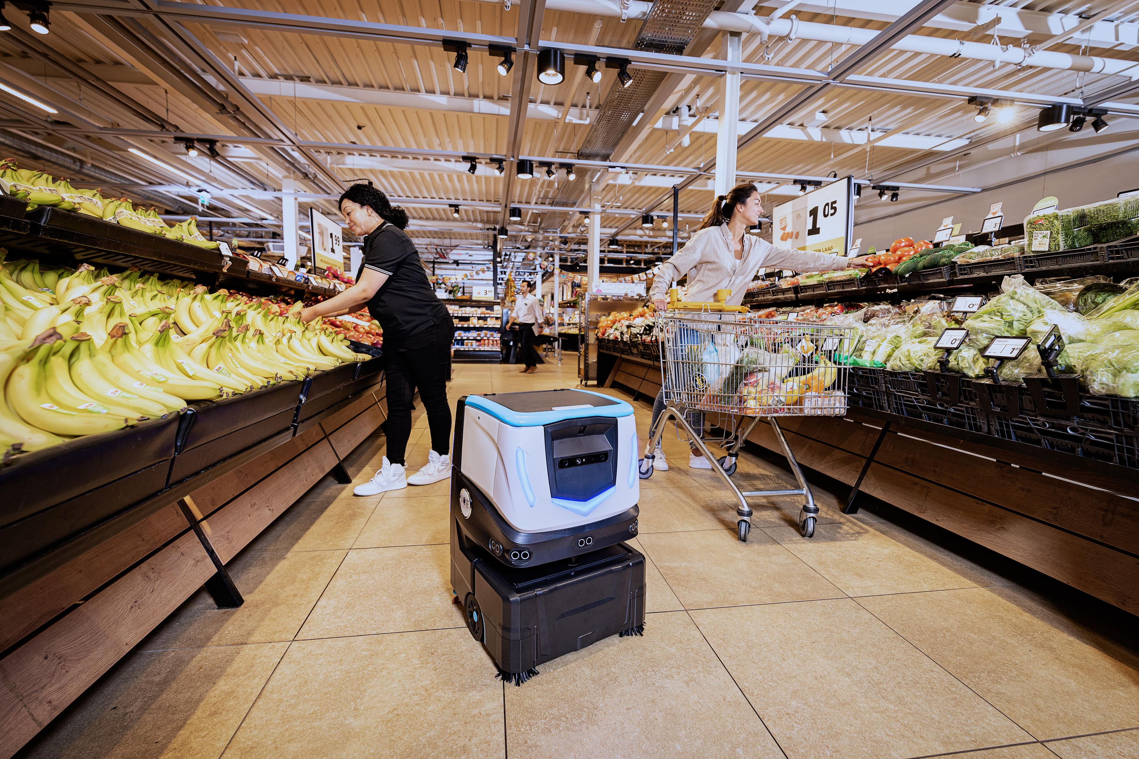 Cobi 18 by ICE Cobotics cleaning floors in grocery retail store produce section.