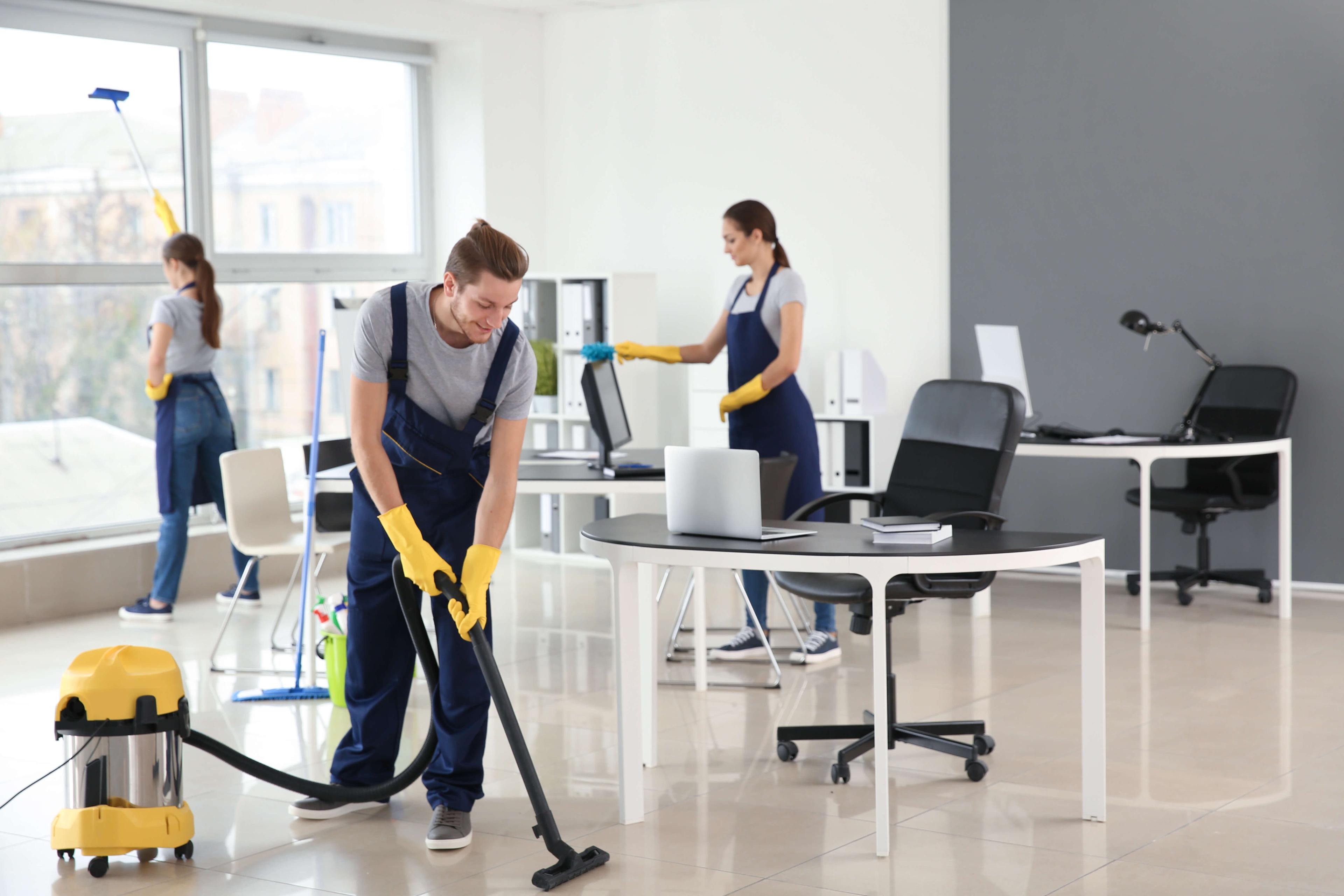 BSC cleaning team working in office buiilding cleaning floors, windows, desks 