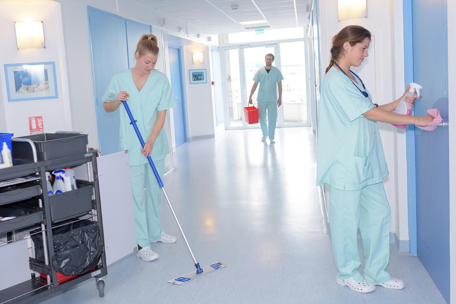 EVS staff cleaning floors, disinfecting door handles in hospital