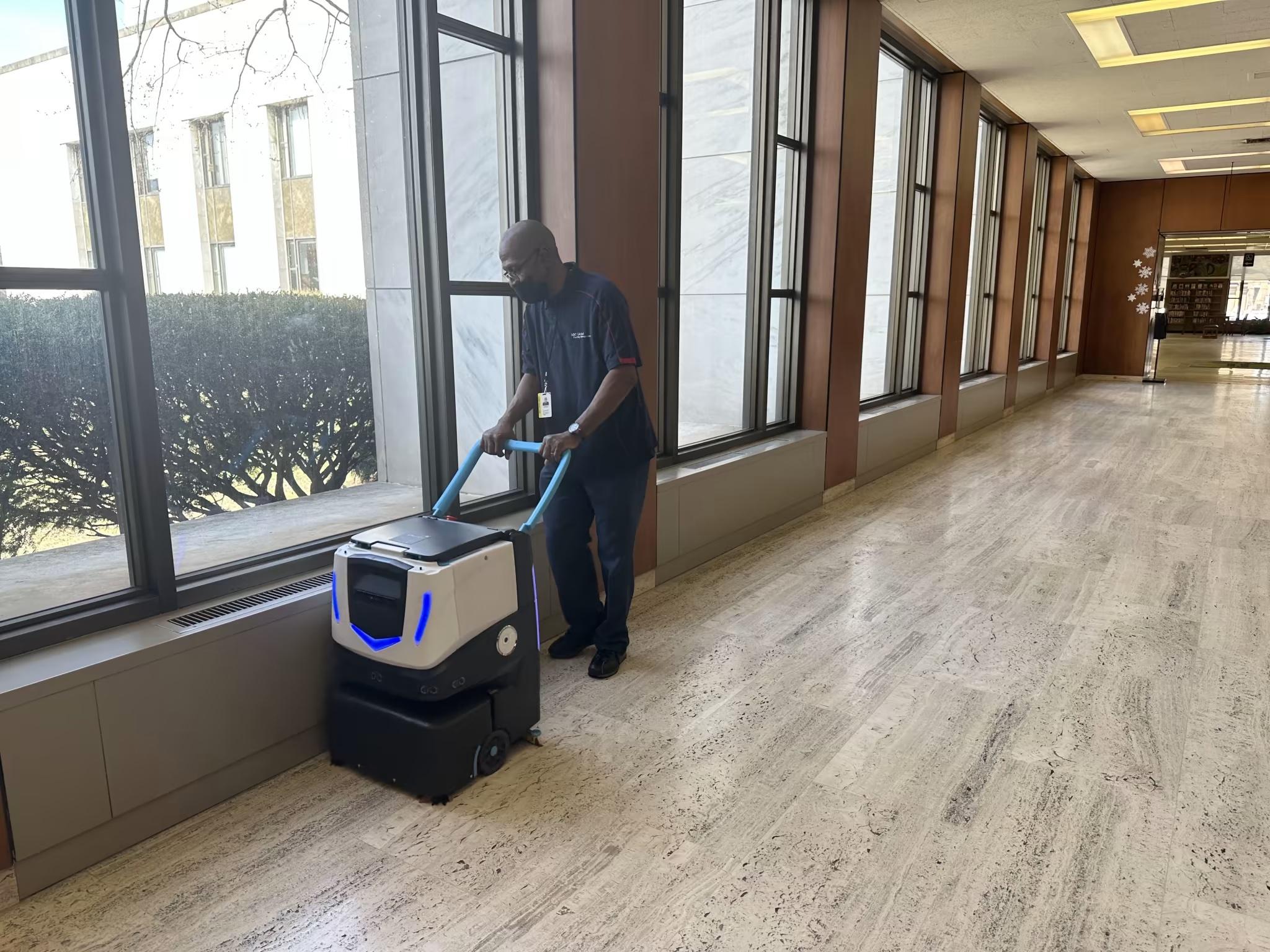 ICE Cobotics Cobi 18 collaborating with cleaning staff in commercial property.