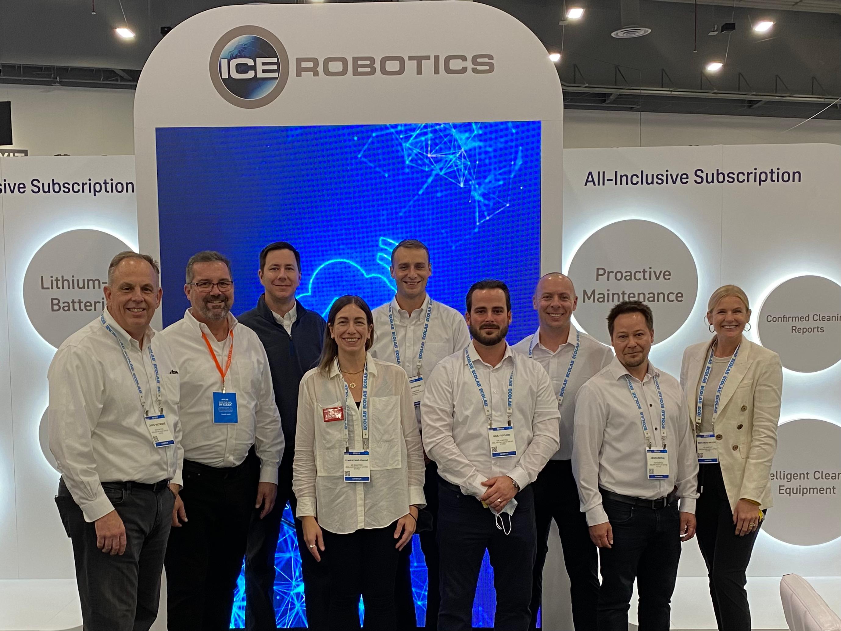 ICE Cobotics ISSA 2021 team members stand in front of large video wall playing fleet management technology video