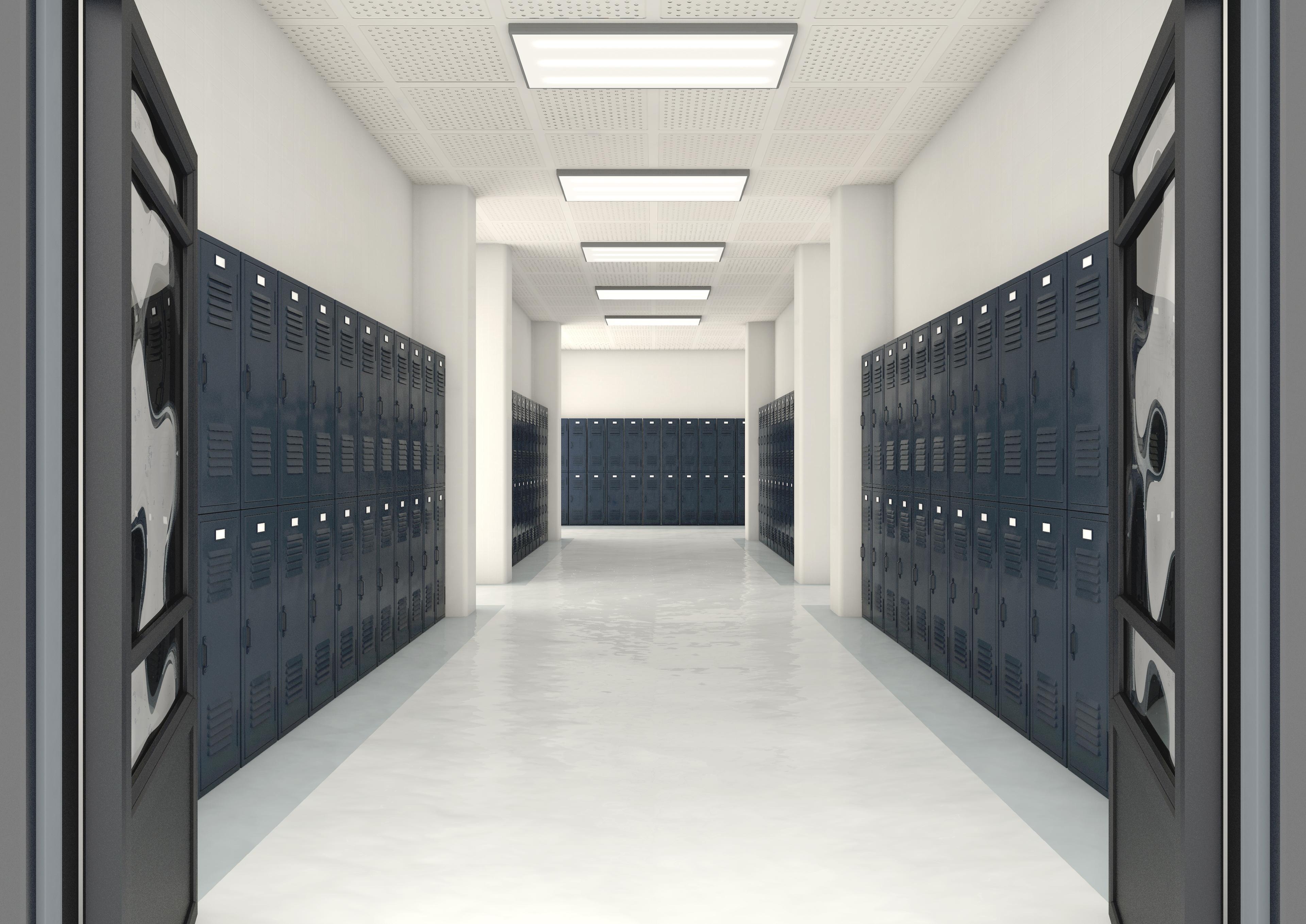 long hallway with lockers and clean white floors in high school 