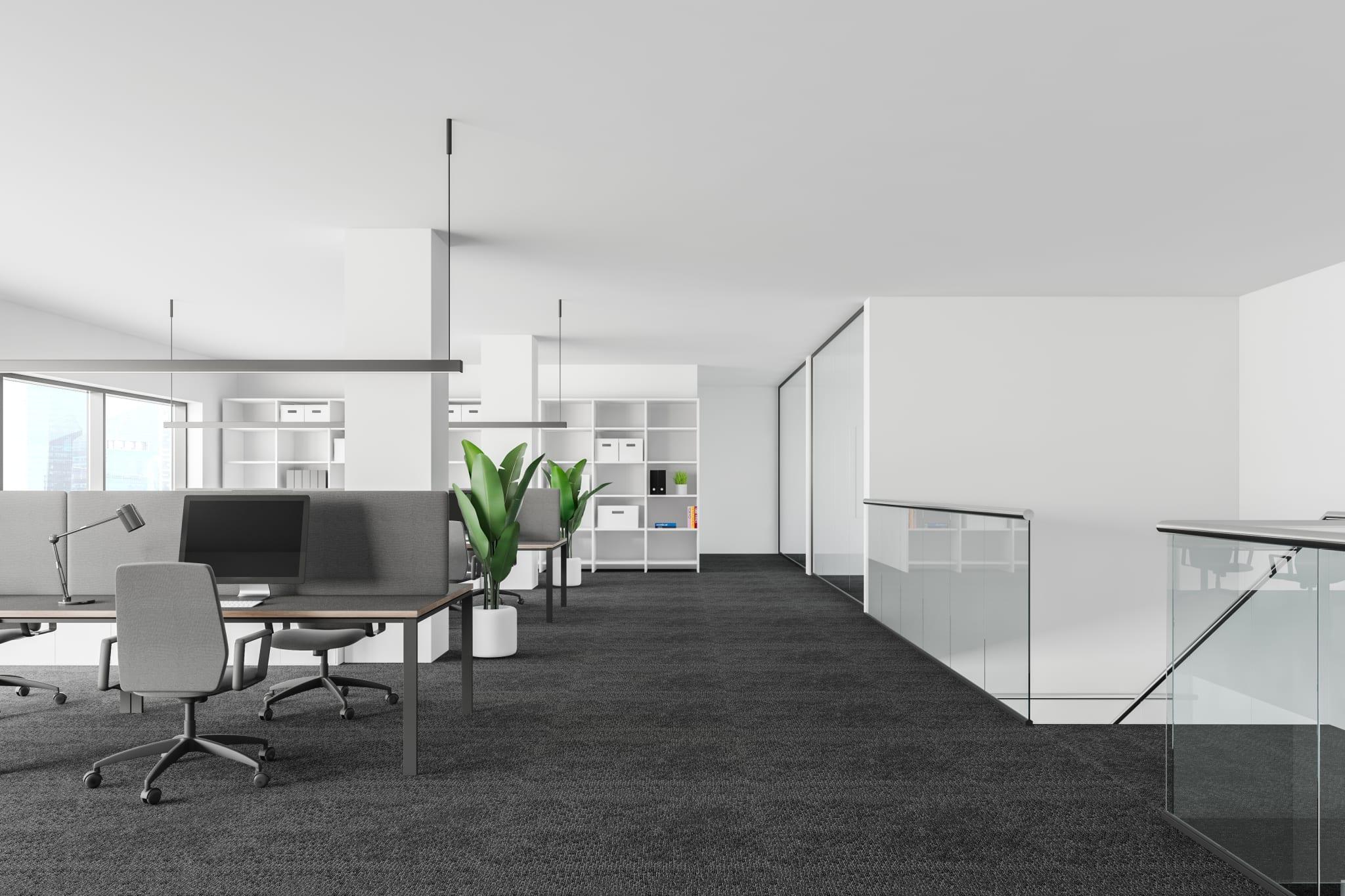 Open floor plan with desk and chair in office in office setting