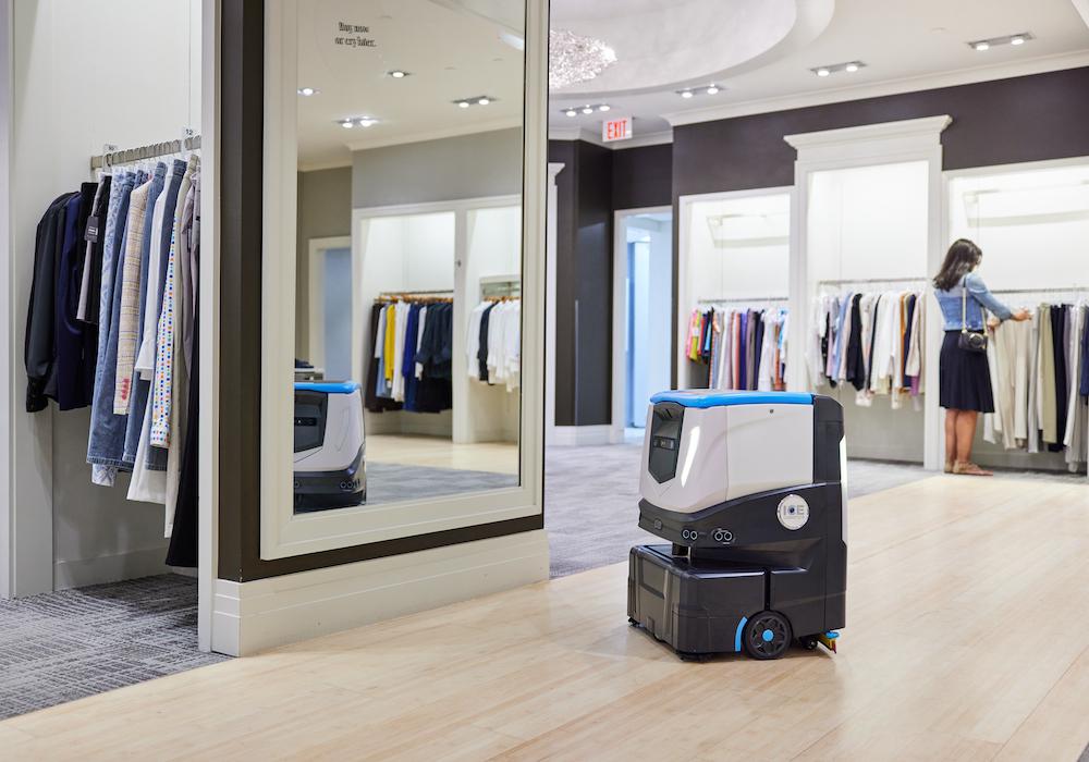 ICE Cobotics' Cobi 18 cleaning clothing retail store while customers shop