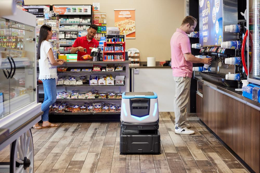 ICE Cobotics' Cobi 18 cleaning convenience store while customer get drinks