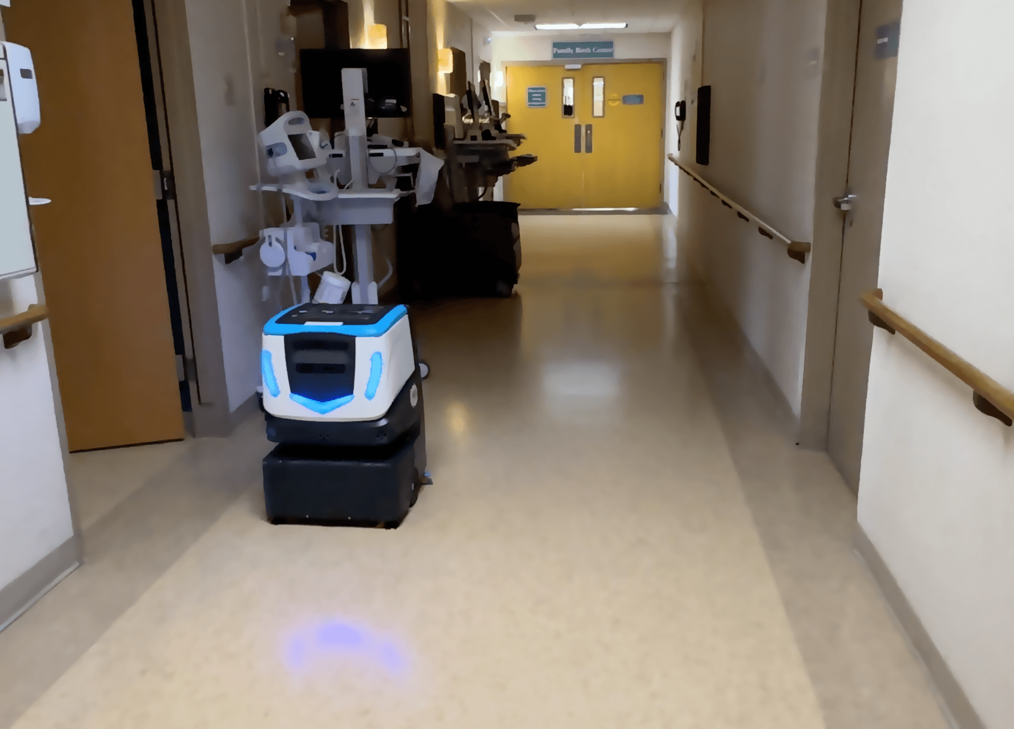 robotic floor scrubber, Cobi 18, cleaning a hospital hallway