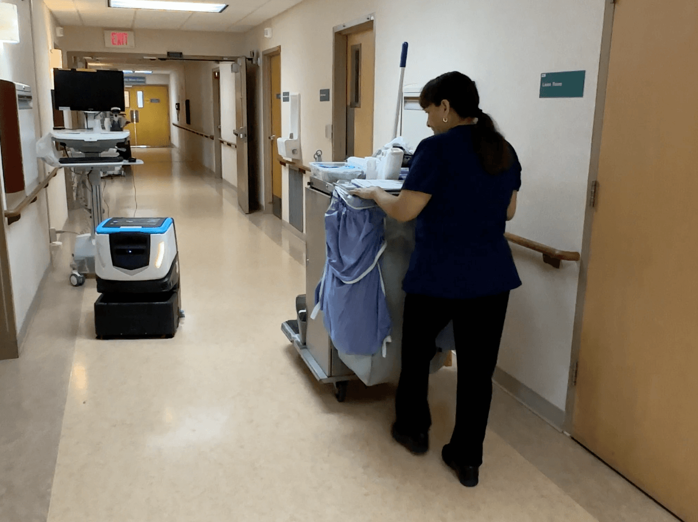 Cobi 18, robotic floor scrubber, cleaning hallway in healthcare facility