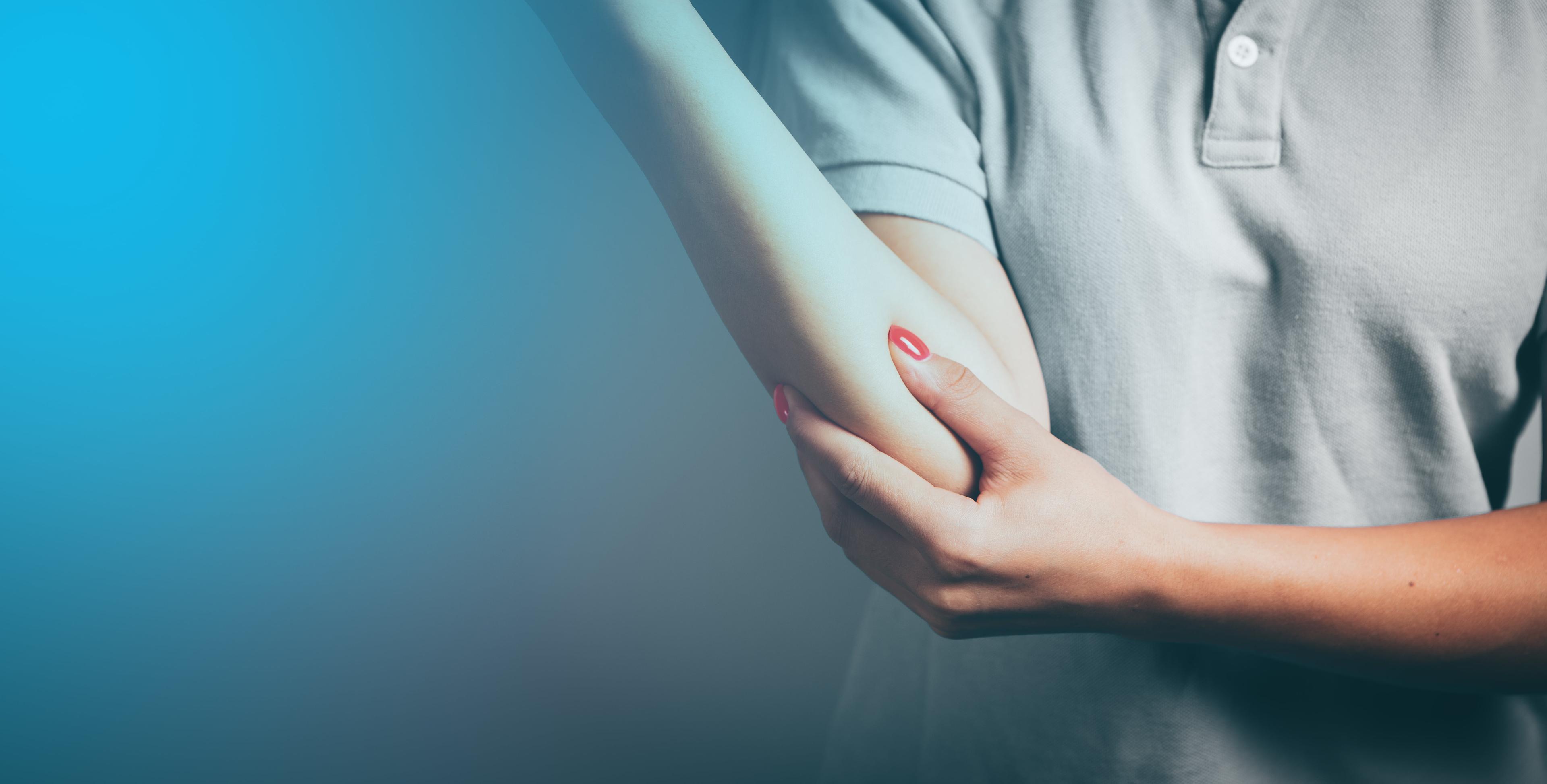 person holding elbow to symbolize pain and injury